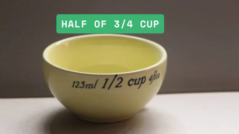 Clear measuring cup with a washi tape marker drawn at the half of 3/4 cup